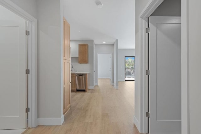 corridor with light hardwood / wood-style floors