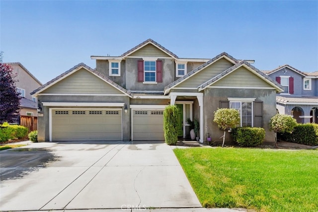 craftsman inspired home featuring a front yard and a garage