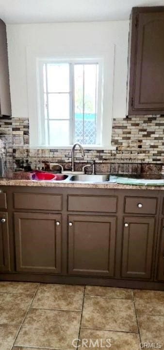 kitchen featuring decorative backsplash and light tile patterned flooring