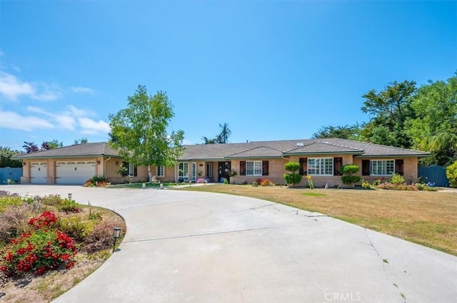 single story home with a front lawn and a garage