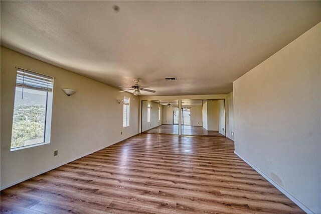 unfurnished living room featuring ceiling fan and light wood-type flooring