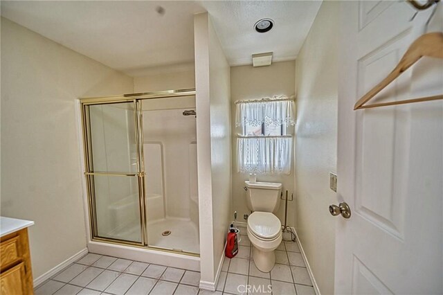 bathroom featuring vanity, toilet, tile patterned floors, and an enclosed shower