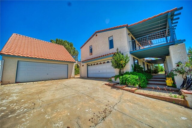 view of front of home with a garage and a balcony