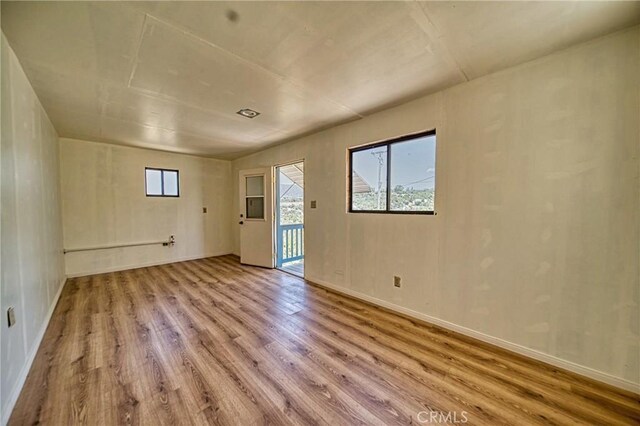 unfurnished room with light hardwood / wood-style floors