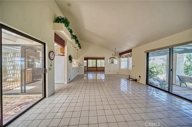 interior space with high vaulted ceiling and a chandelier