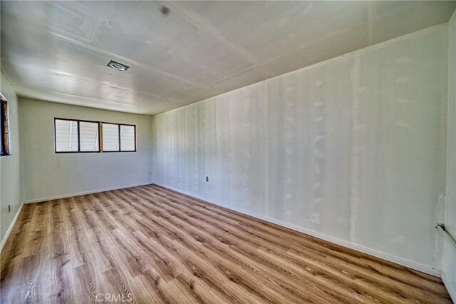 spare room with light hardwood / wood-style floors