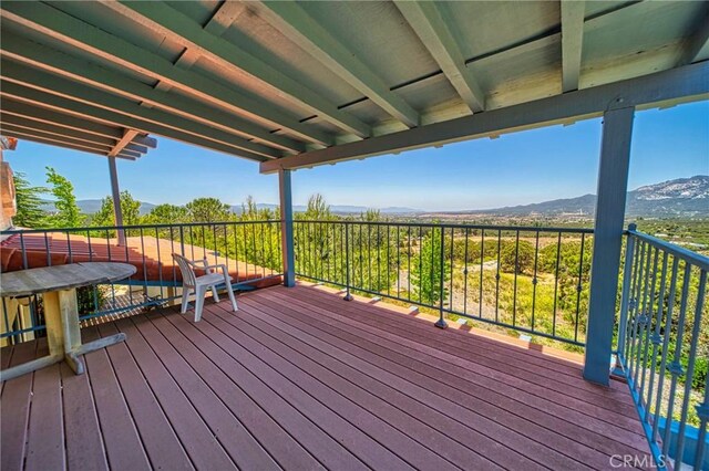 wooden deck featuring a mountain view