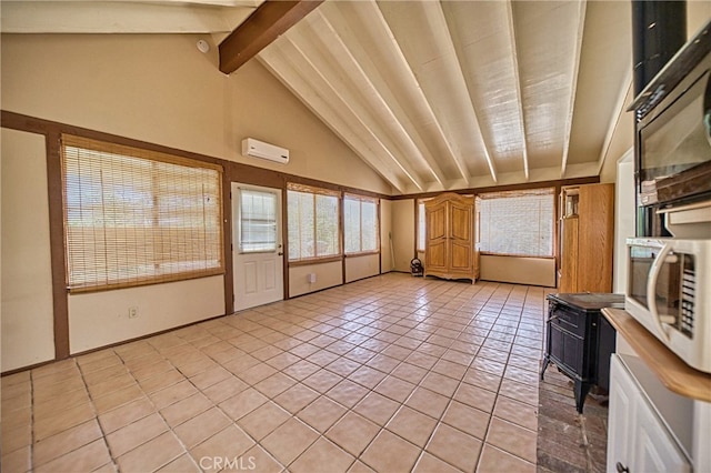 unfurnished sunroom featuring vaulted ceiling with beams