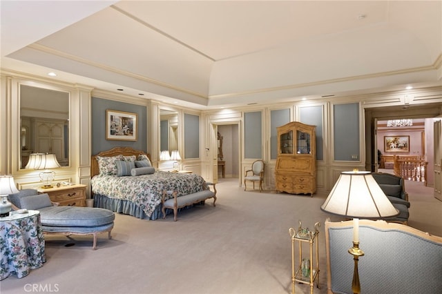 bedroom with a raised ceiling, crown molding, and carpet floors