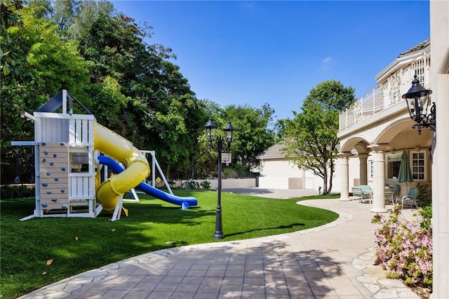 view of play area with a patio area and a yard