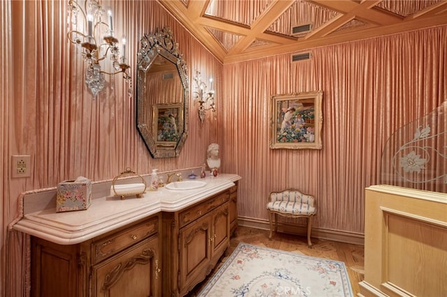 bathroom with vanity, wooden walls, and coffered ceiling