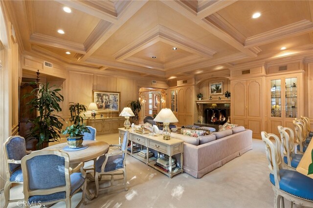 living room with beam ceiling, crown molding, light colored carpet, and coffered ceiling