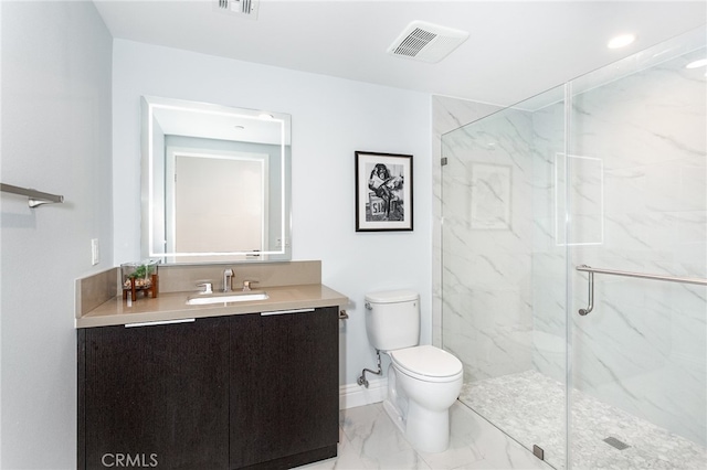 bathroom featuring toilet, vanity, and a shower with door