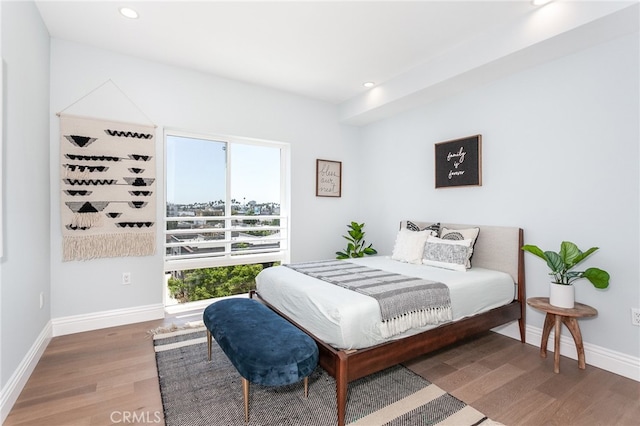 bedroom with dark hardwood / wood-style floors