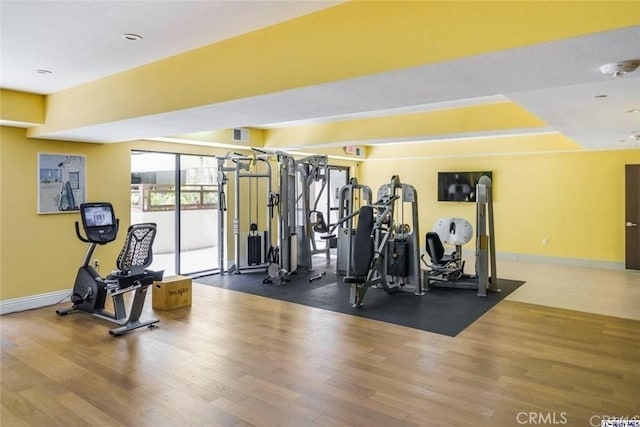 exercise room with hardwood / wood-style flooring