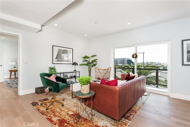 living room featuring a wealth of natural light and light hardwood / wood-style floors