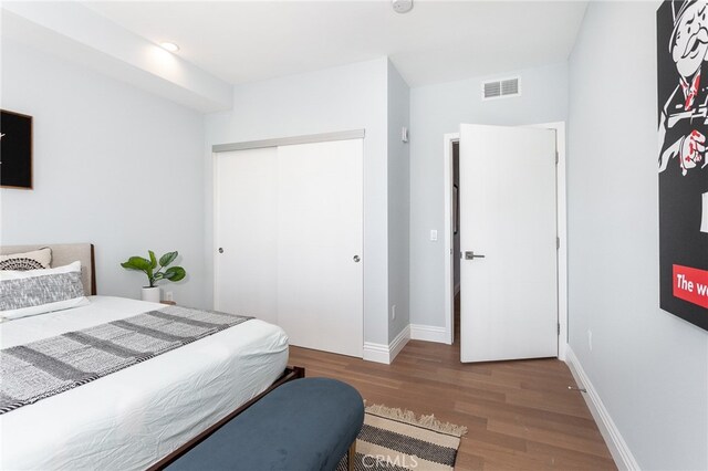 bedroom featuring a closet and dark hardwood / wood-style floors