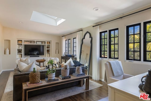 living room featuring a skylight and hardwood / wood-style flooring