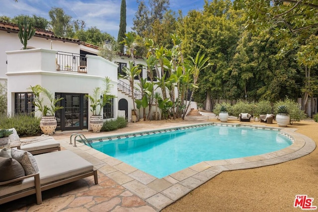 view of swimming pool with a patio