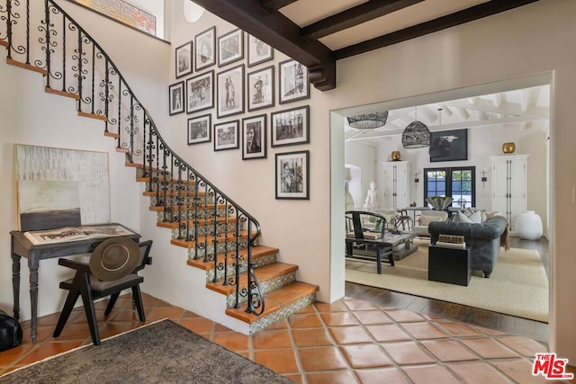 stairs featuring tile patterned flooring and french doors