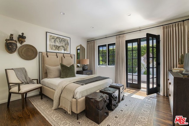 bedroom featuring dark hardwood / wood-style floors, french doors, and access to outside