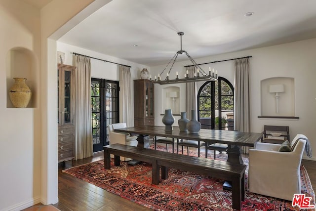 dining area featuring an inviting chandelier and hardwood / wood-style floors