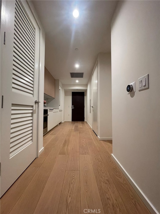 hall with light wood-type flooring