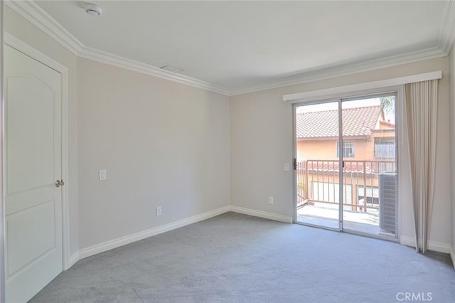 empty room featuring light colored carpet and ornamental molding