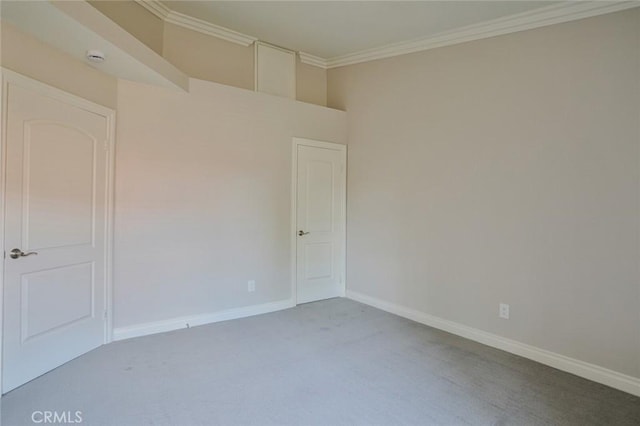 carpeted spare room with ornamental molding