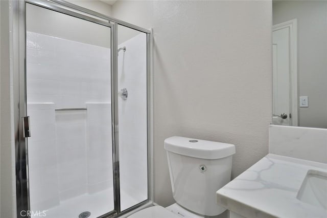 bathroom with toilet and a shower with door