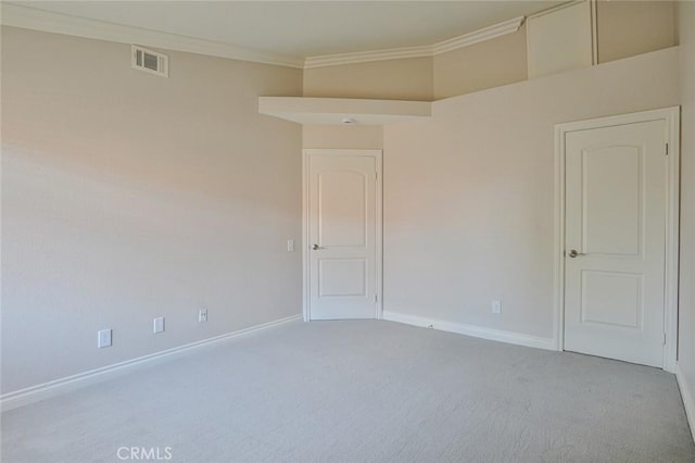 carpeted spare room with ornamental molding