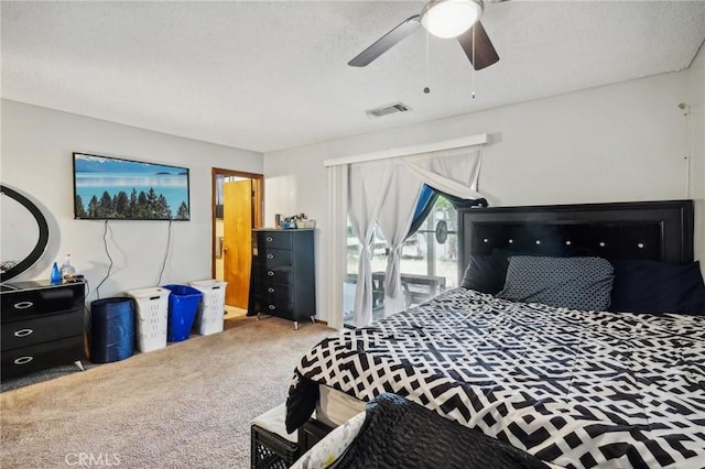 bedroom with carpet, ceiling fan, and a textured ceiling