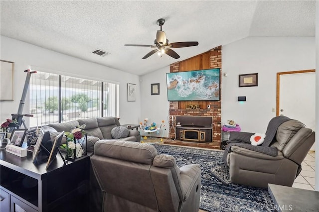 living room with a textured ceiling, a wood stove, ceiling fan, and lofted ceiling