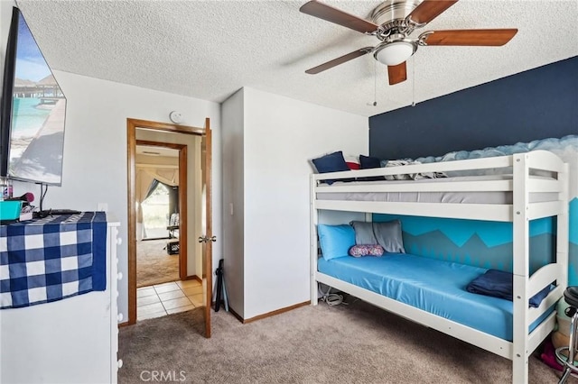 bedroom featuring a textured ceiling, carpet floors, and ceiling fan