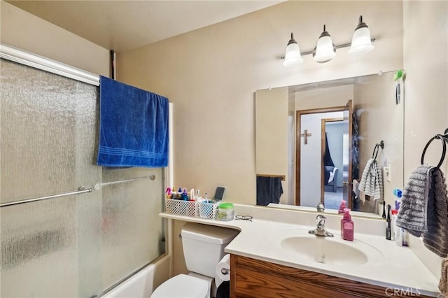 full bathroom featuring shower / bath combination with glass door, vanity, and toilet