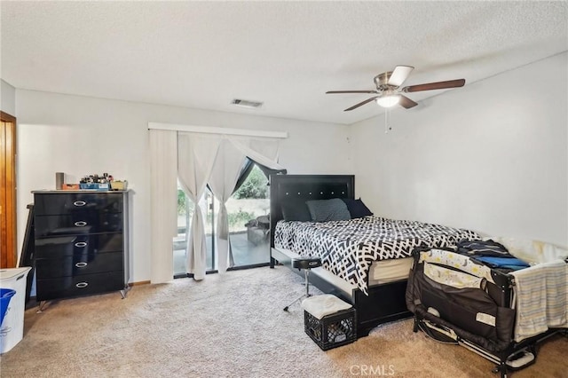 bedroom with carpet flooring, access to exterior, ceiling fan, and a textured ceiling