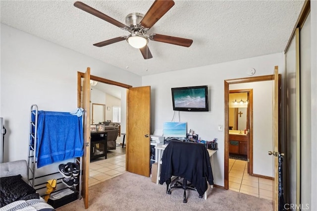 carpeted office featuring ceiling fan and a textured ceiling