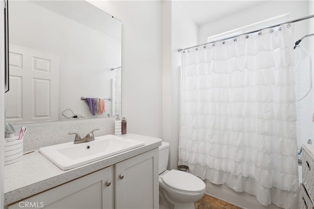 full bathroom with vanity, toilet, and shower / bath combo with shower curtain