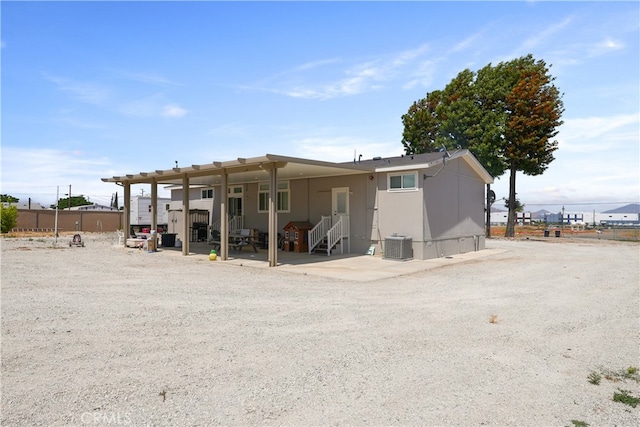 rear view of house with a pergola, a patio, and central air condition unit