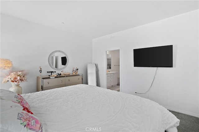 carpeted bedroom featuring connected bathroom