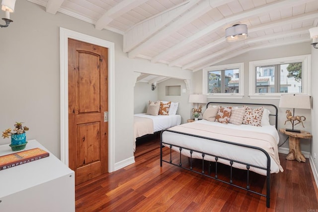 bedroom with lofted ceiling with beams and dark hardwood / wood-style floors