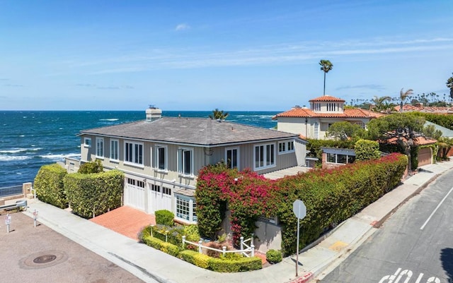 view of front of property featuring a water view and a garage