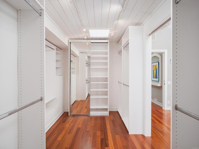 spacious closet featuring dark hardwood / wood-style floors