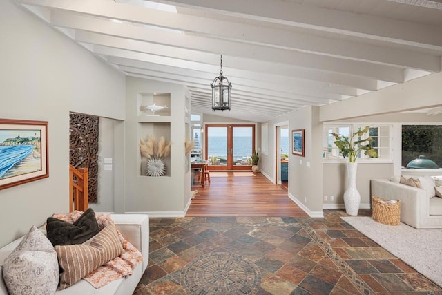 hallway with lofted ceiling with beams and french doors