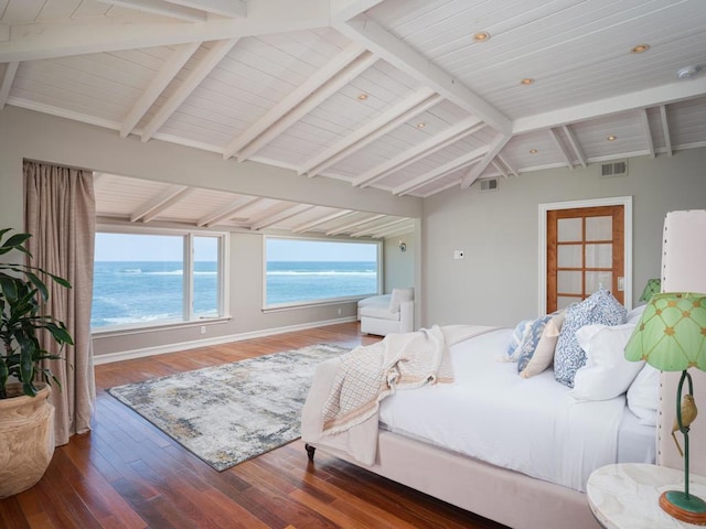 bedroom with a beach view, dark wood-type flooring, lofted ceiling with beams, and a water view