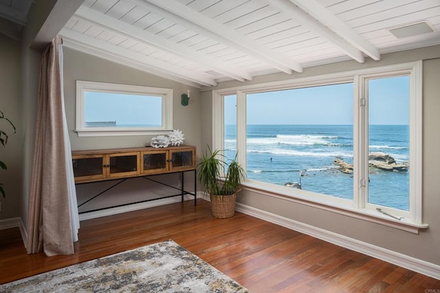 interior space featuring a water view and vaulted ceiling with beams