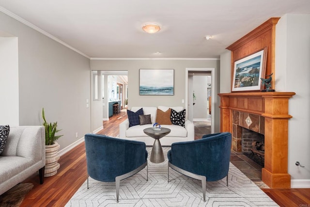 living room featuring hardwood / wood-style flooring, crown molding, and a fireplace