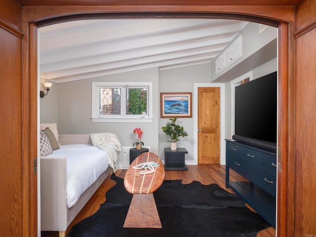 bedroom with hardwood / wood-style floors and lofted ceiling with beams