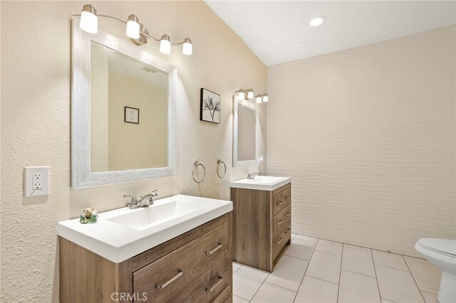 bathroom featuring tile patterned flooring, vanity, and toilet