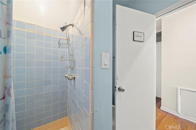 bathroom featuring a shower with curtain and hardwood / wood-style flooring